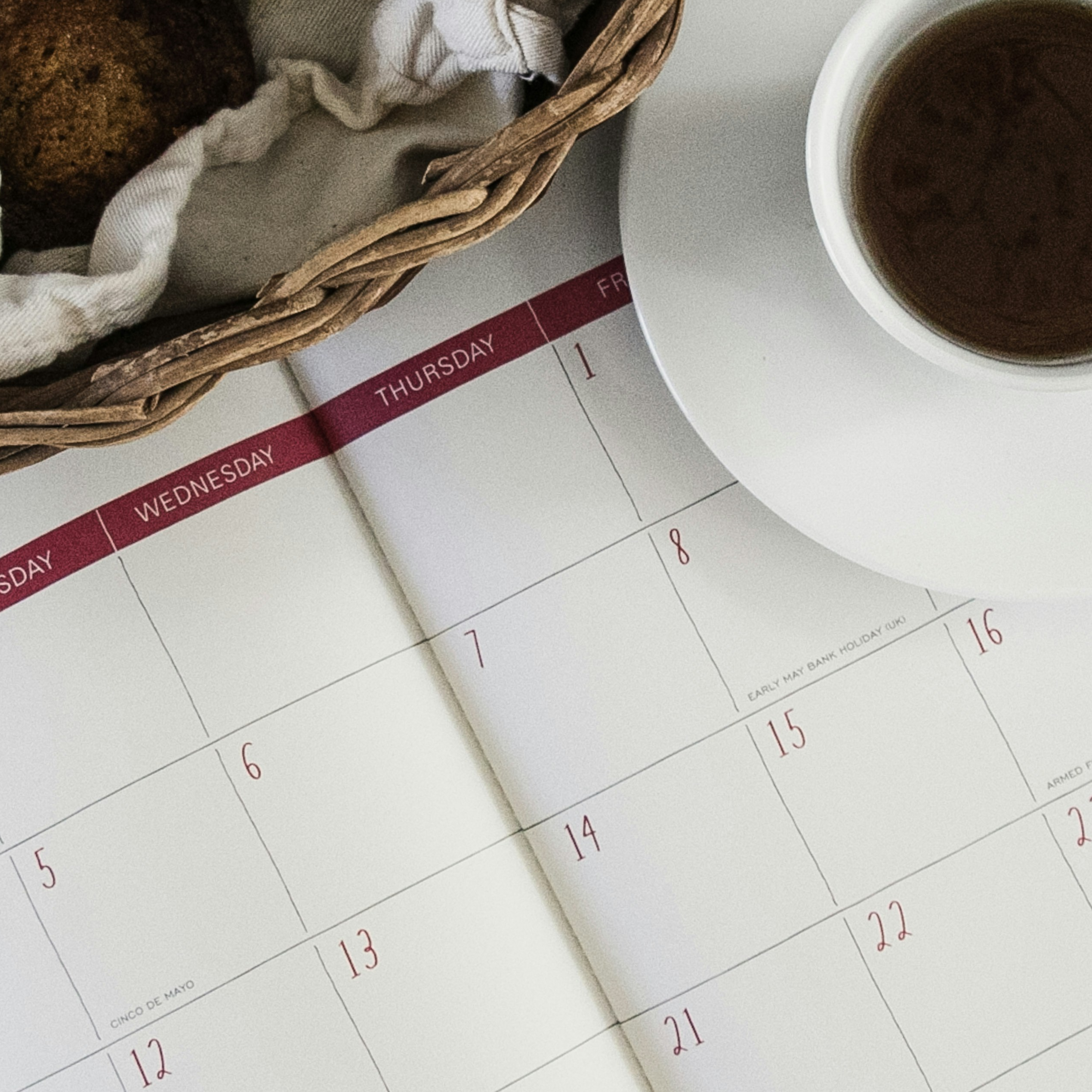 Weekly calendar framed by cup of coffee.